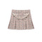 A pleated tweed mini skirt in a pink, beige, and black bouclé pattern, featuring a decorative cream-colored faux-pearl curved belt detail across the waistband, shown against a plain white background.