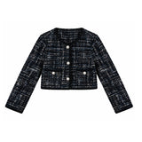 A cropped tweed jacket with long sleeves, featuring a black and white textured weave, a round neckline, three silver-tone buttons, and two front flap pockets with decorative buttons.