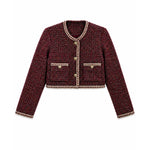 A cropped tweed jacket in a dark red and black micro-tweed pattern, featuring beige and gold trim along the collar, cuffs, hem, and front buttons.