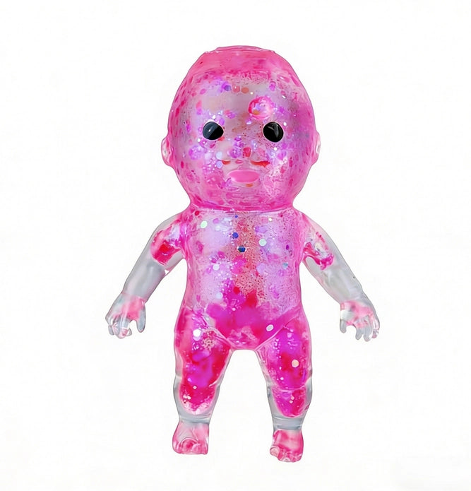 Pink baby gummy squishy with a glittery texture on a white background