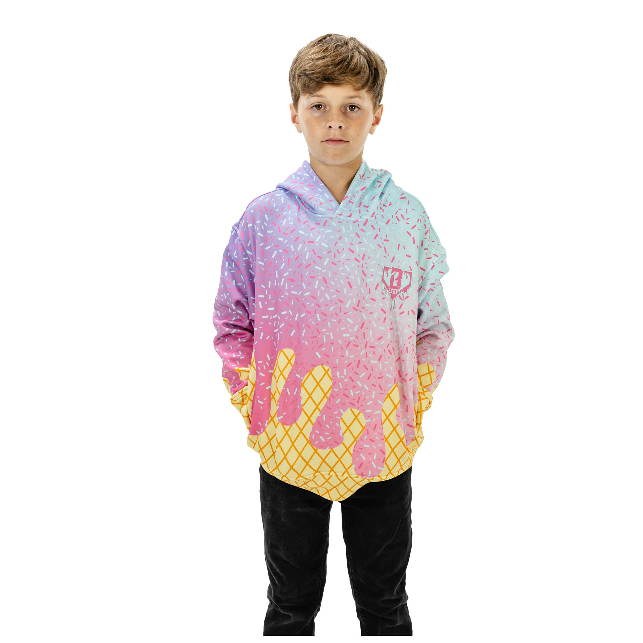 A young boy modeling a pastel gradient hoodie with a pink and blue top, yellow bottom, and a dripping ice cream cone design, set against a plain white background.
