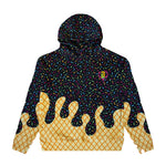 A black pullover hoodie featuring a multicolor sprinkle pattern on the upper body and sleeves, with a yellow waffle-grid pattern on the lower body and sleeves, and dark chocolate drip graphics across the waist. A small colorful graphic is printed on the left chest.