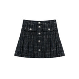 A black and gray tweed pleated mini skirt with a button-up front and decorative silver-tone buttons, shown flat on a white background.