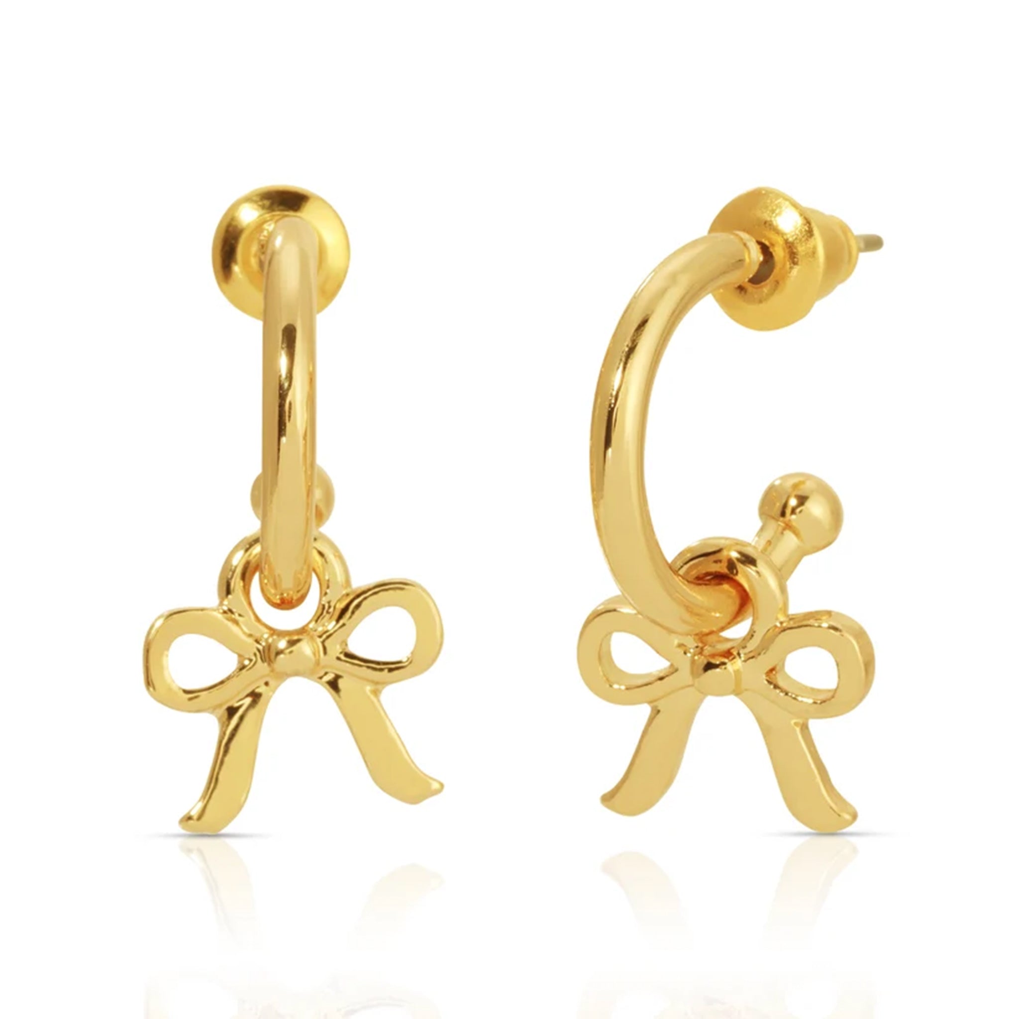 Gold hoop earrings with bow charms on a white background