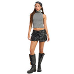 A model wearing a gray ribbed sleeveless crop top, a black faux-leather mini skirt with silver studs and a wide belt, distressed black knee-high boots, and a black bandana, set against a plain white background.