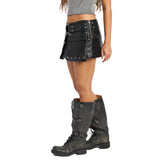 A model wearing a black faux-leather mini skirt with silver studs and a matching belt, paired with distressed black lace-up boots, shown from the waist down on a white background.