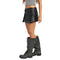 A model wearing a black faux-leather mini skirt with silver studs and a matching belt, paired with distressed black lace-up boots, shown from the waist down on a white background.
