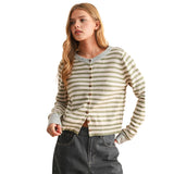 A woman modeling a cropped, long-sleeve knit cardigan with horizontal olive green and cream stripes, featuring brown buttons down the front against a solid white background.