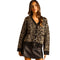 A woman modeling a brown and black leopard print knit cardigan with a V-neck, button-front closure, and ribbed trim against a plain white background.