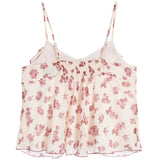 A white camisole top with a pink floral print, featuring thin adjustable straps and a smocked waist.