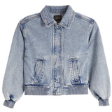 A light blue denim jacket with a collar, front zipper, and two vertical flap pockets, shown on a plain white background.