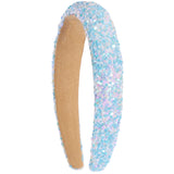 A sequin headband with light blue, lavender, and pink iridescent sequins on the outside and a natural tan fleece lining on the inside, shown against a plain white background.