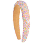 A wide headband covered in pastel sequins with a tan inner lining, shown on a plain white background.