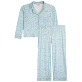 A two-piece pajama set featuring a light blue long-sleeve button-up top and matching pants, both decorated with a delicate yellow and white floral pattern, displayed on a solid white background.