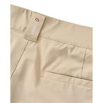 Close-up of the waistband and pocket area of beige trousers, showing a fabric brand tab with the word 'johnnie-o' and a small red circular logo.
