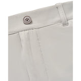 Close-up detail of light beige shorts showing the waistband, belt loop, and a four-hole button.