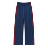 A pair of navy blue wide-leg athletic pants with red and white side stripes, featuring an elastic waistband, shown against a plain white background.