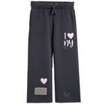 Dark gray wide-leg sweatpants with an elastic drawstring waist, featuring a 'I [heart] ny' graphic on the right leg, a pink heart patch on the left leg, and small white 'x x x' details near the hem.