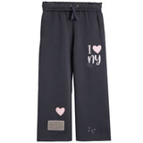 Dark gray wide-leg sweatpants with an elastic drawstring waist, featuring a 'I [heart] ny' graphic on the right leg, a pink heart patch on the left leg, and small white 'x x x' details near the hem.
