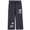 Dark gray wide-leg sweatpants with an elastic drawstring waist, featuring a 'I [heart] ny' graphic on the right leg, a pink heart patch on the left leg, and small white 'x x x' details near the hem.