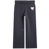 Dark charcoal gray wide-leg sweatpants with an elastic waistband and a small light pink heart graphic on the upper left leg.