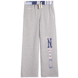 A pair of heather gray sweatpants featuring a vertical 'NYC' graphic on the left leg in a pattern, with a matching patterned waistband and drawstring.