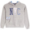A heather gray pullover hoodie with a navy blue and white patterned 'NYC' graphic on the chest, a matching bow motif on the left front, and a blue-and-white patterned hood lining, shown on a plain white background.