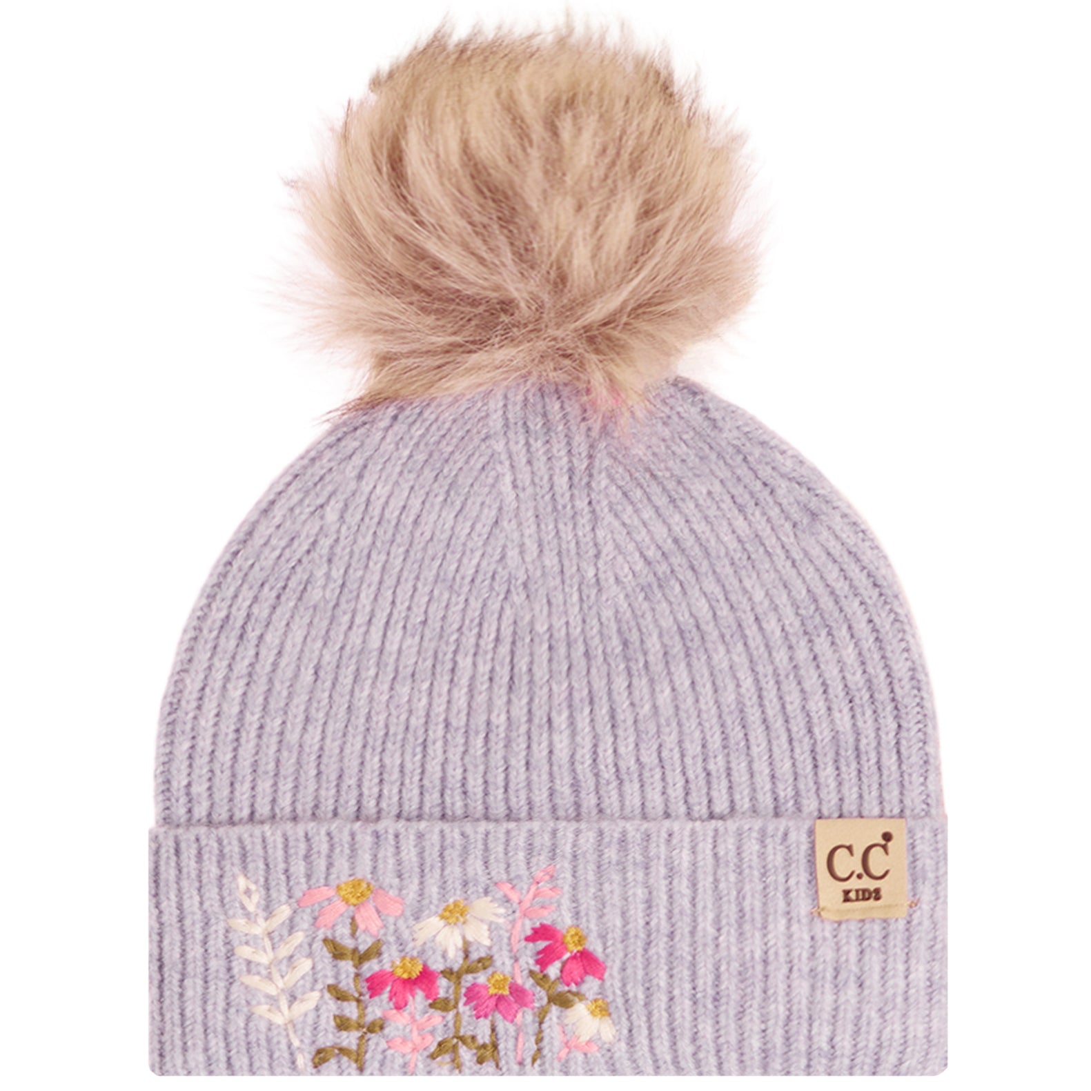 A light lavender ribbed knit beanie hat with a fluffy tan pom-pom on top and floral embroidery on the front cuff. A small tan brand patch reading 'c.