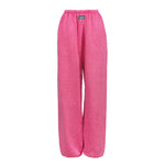 Bright pink wide-leg sweatpants with an elastic waistband and a small black brand patch on the front, shown against a plain white background.