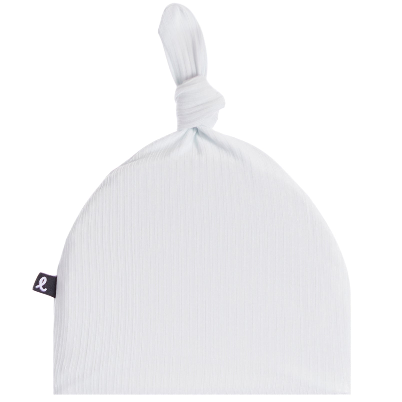 A white ribbed muslin baby hat with a knotted top and a small black fabric brand tag on the side, shown against a plain white background.