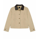 A beige cropped jacket with a dark brown leather collar, featuring three front buttons and two large front patch pockets, shown flat on a white background.