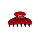 A glossy red claw hair clip with a gold metal spring mechanism, shown from the front on a solid white background.