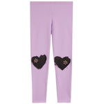 Light purple leggings with two black heart-shaped patches on the lower legs, each decorated with small metallic rhinestones, shown against a plain white background.