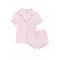 A two-piece children's pajama set by Katie J NYC, featuring a short-sleeve button-front pajama top and matching shorts in light pink with a delicate ballet dancer print and light blue piping details.