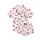 A two-piece women's pajama set featuring a short-sleeve button-front top and matching shorts in light pink, printed with an all-over dachshund pattern and finished with black piping and a black drawstring.