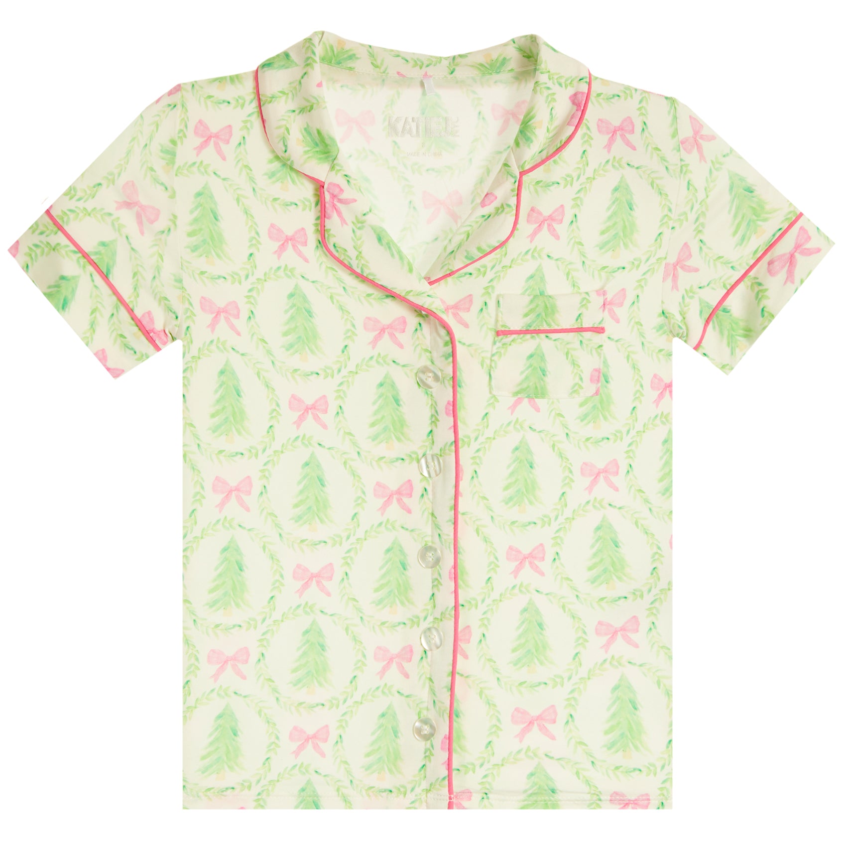 A short-sleeve button-front pajama top with a green and pink holiday print featuring wreaths, Christmas trees, and bows, shown flat against a white background.