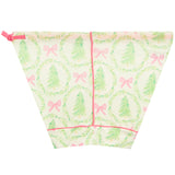 A triangular fabric drawstring bag with a Christmas-themed print featuring green pine trees, pink bows, and green wreaths on a cream background, finished with pink trim and a pink drawstring tie.