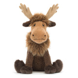 A plush moose toy with large tan antlers, a light brown face, and dark brown fur, sitting against a plain white background.