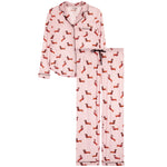 A two-piece pajama set consisting of a long-sleeve button-up top and matching pants in light pink, covered in an all-over print of small red and black dachshund dogs. The pajama set is displayed flat against a solid white background.