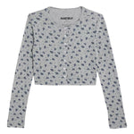 A light gray long-sleeve cropped cardigan with a small dark blue floral pattern, featuring a button-up front.