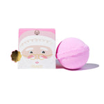 A pink bath bomb next to its illustrated packaging box featuring a Santa face design, on a clean white background.