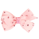 A light pink ribbon hair bow decorated with small pink rhinestones and a central cluster of pink pearls, shown on a plain white background.