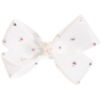 A white ribbon hair bow embellished with small rhinestones and a central pearl cluster, shown against a plain white background.