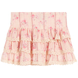 A light pink tiered ruffle skirt with a delicate floral print and lace trim, shown flat against a white background.