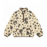 A cream-colored sherpa fleece pullover jacket with a black paisley and floral pattern, featuring brown trim on the collar, zipper, and pocket edges.