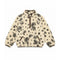 A cream-colored sherpa fleece pullover jacket with a black paisley and floral pattern, featuring brown trim on the collar, zipper, and pocket edges.