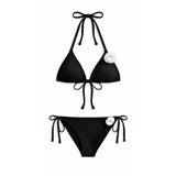 Black bikini set with white flowers on a white background
