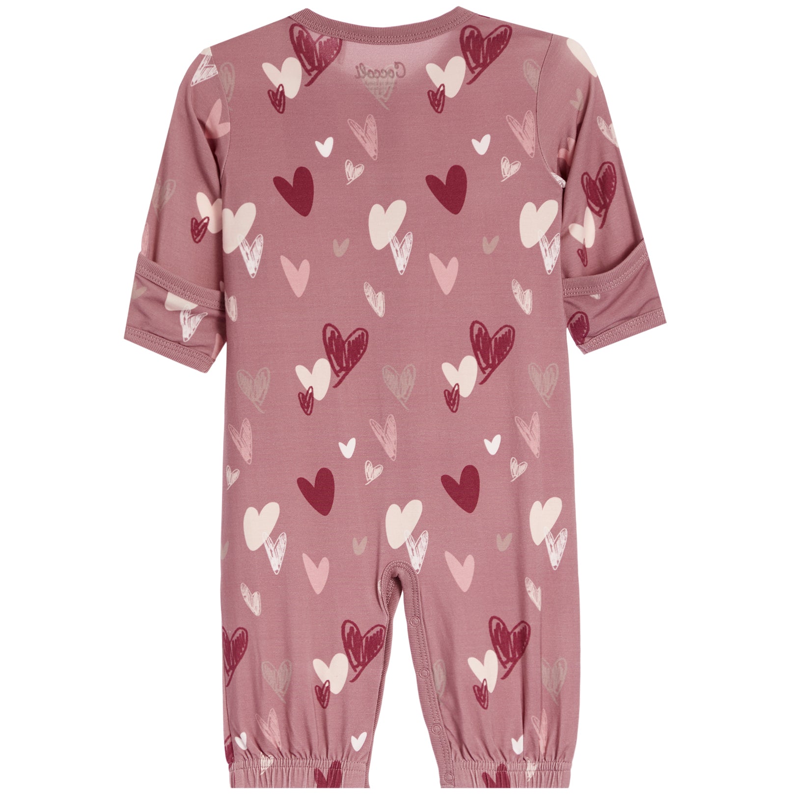 A dusty rose pink baby jumpsuit with an all-over heart pattern in shades of red, pink, and white. The jumpsuit features long sleeves with rolled cuffs, elasticated ankles, and a small 'bopppp' brand logo printed inside the collar.