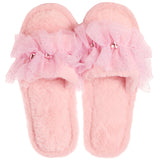 A pair of fluffy pink slip-on slippers decorated with layered tulle flower bows and small rhinestone accents, shown on a plain white background.