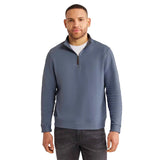 A man wearing a textured, quarter-zip knit sweater in slate blue photographed against a solid white background.